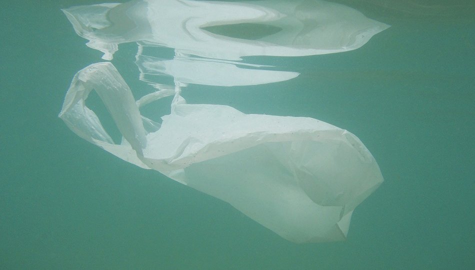 Plastic bag floating into the sea. Polluted enviromental. Recycl